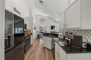 a kitchen with a sink stove and refrigerator