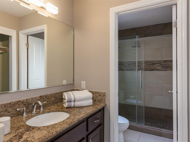 7209 Emami Drive San Jose, CA 95120 - Photo 13 of 33 a bathroom with a granite countertop sink a toilet a mirror and shower