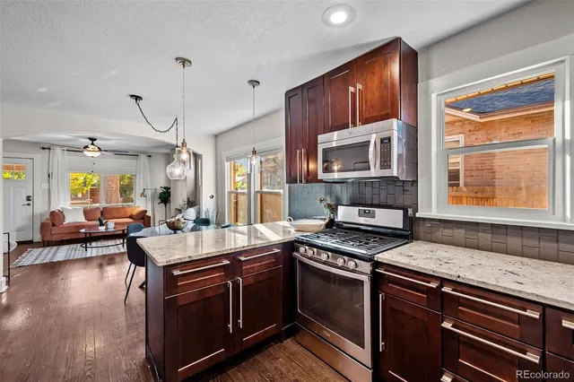 a kitchen with sink stove and cabinets