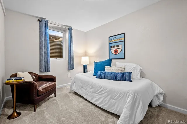 a bedroom with a bed and a couch