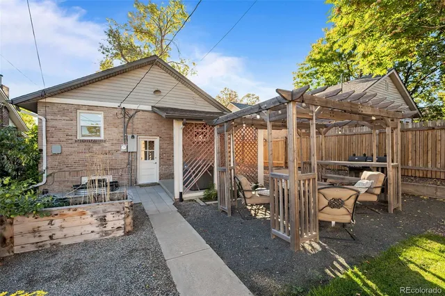 a view of a dinning table and chairs in patio of the house