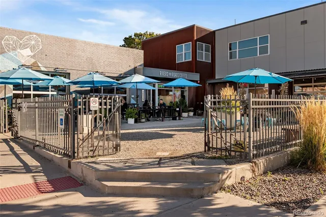 a view of a patio with table and chairs under an umbrella