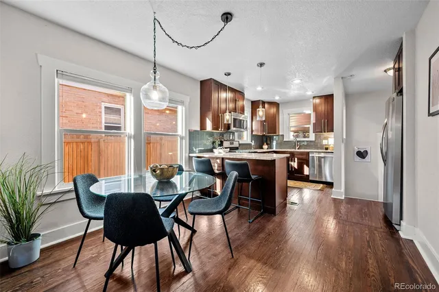 a view of a dining room with furniture window and wooden floor