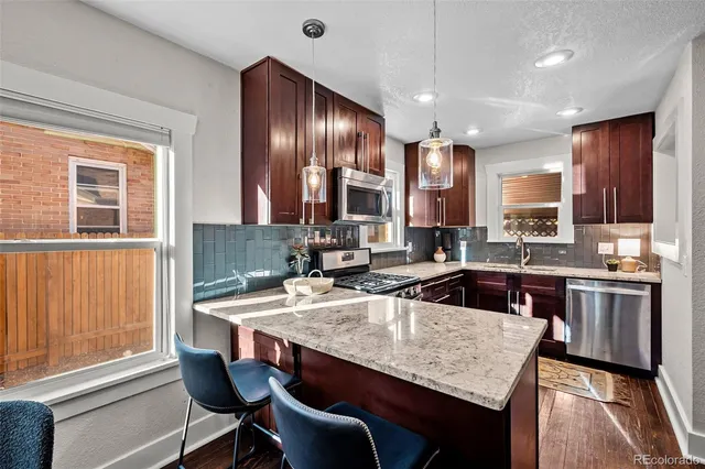 a kitchen with a stove a sink and a refrigerator