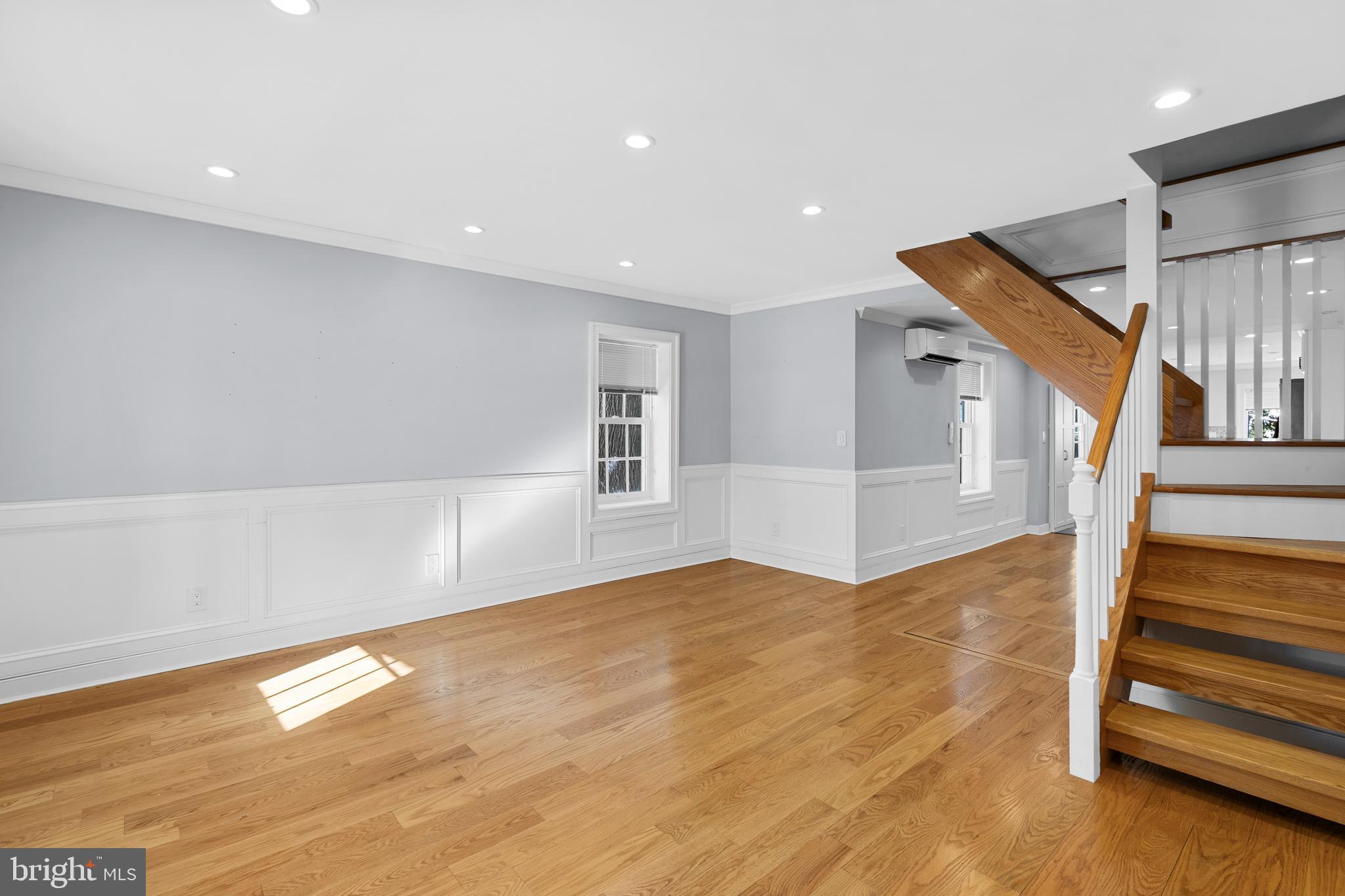 109 Mercer Street Newtown, PA 18940 - Photo 6 of 26 a view of an empty room with wooden floor and stairs