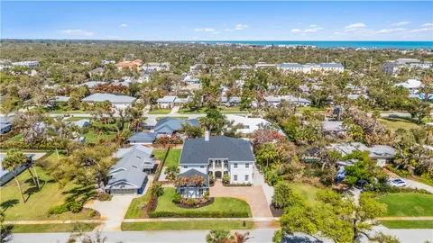 an aerial view of residential houses with outdoor space and swimming pool