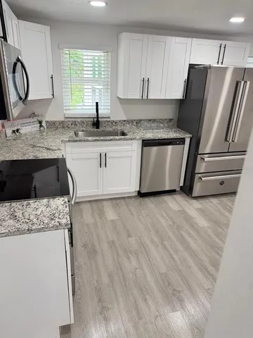 a view of a room with wooden floor and windows