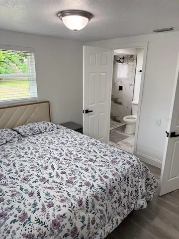 a view of bedroom with wooden floor