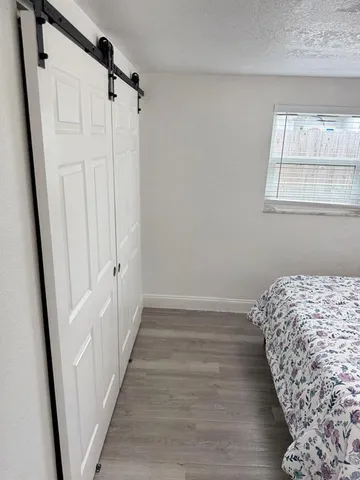 a bathroom with a granite countertop toilet sink and mirror