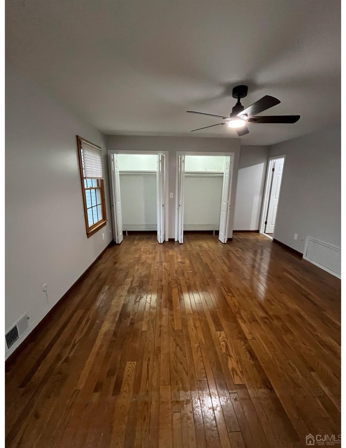 23 Pendleton Place Old Bridge, NJ 08857 - Photo 11 of 14 wooden floor in an empty room with a window