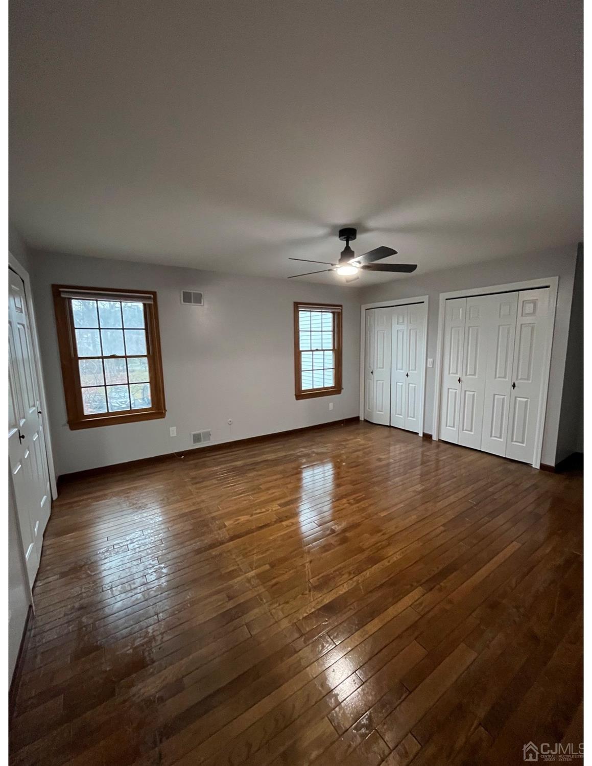 23 Pendleton Place Old Bridge, NJ 08857 - Photo 12 of 14 a view of empty room with wooden floor and fan