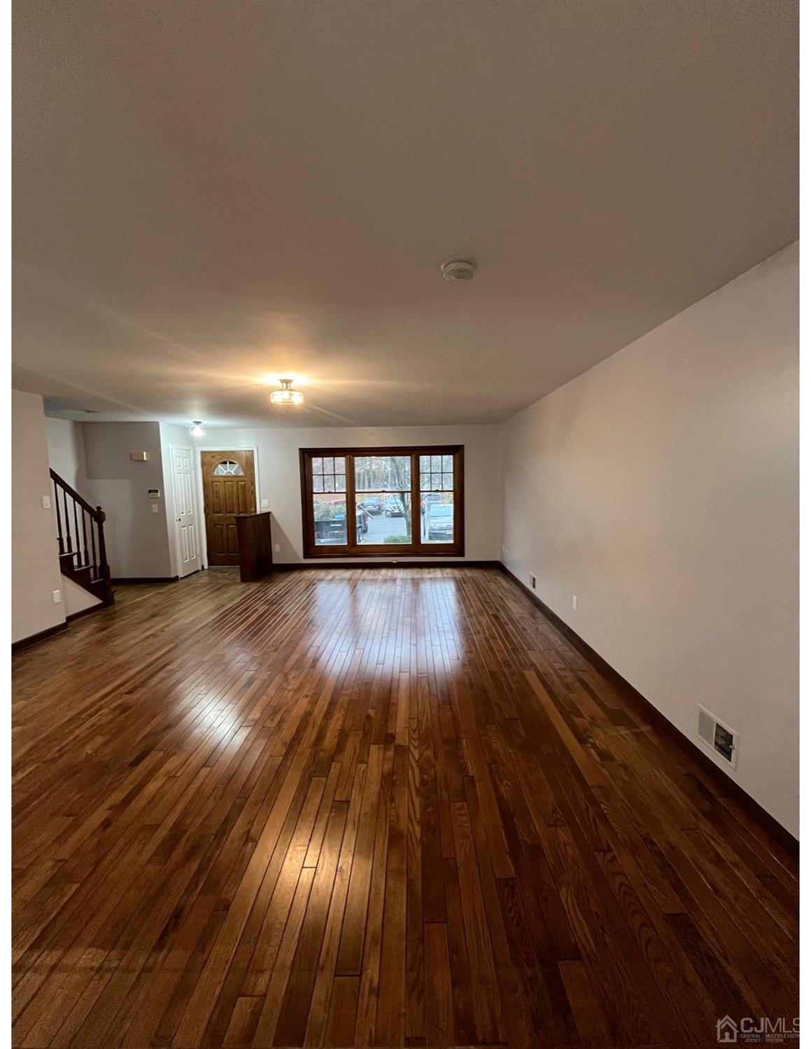23 Pendleton Place Old Bridge, NJ 08857 - Photo 3 of 14 a view of a room with wooden floor and staircase