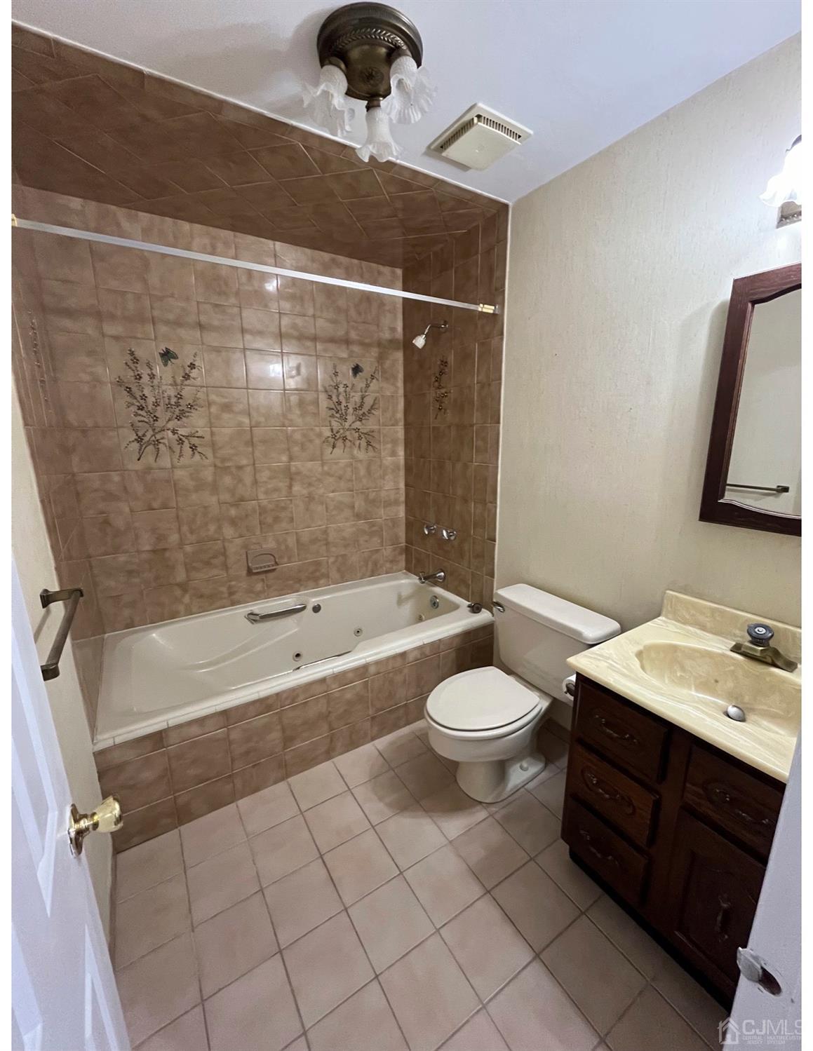 23 Pendleton Place Old Bridge, NJ 08857 - Photo 4 of 14 a bathroom with a bathtub shower sink vanity and toilet