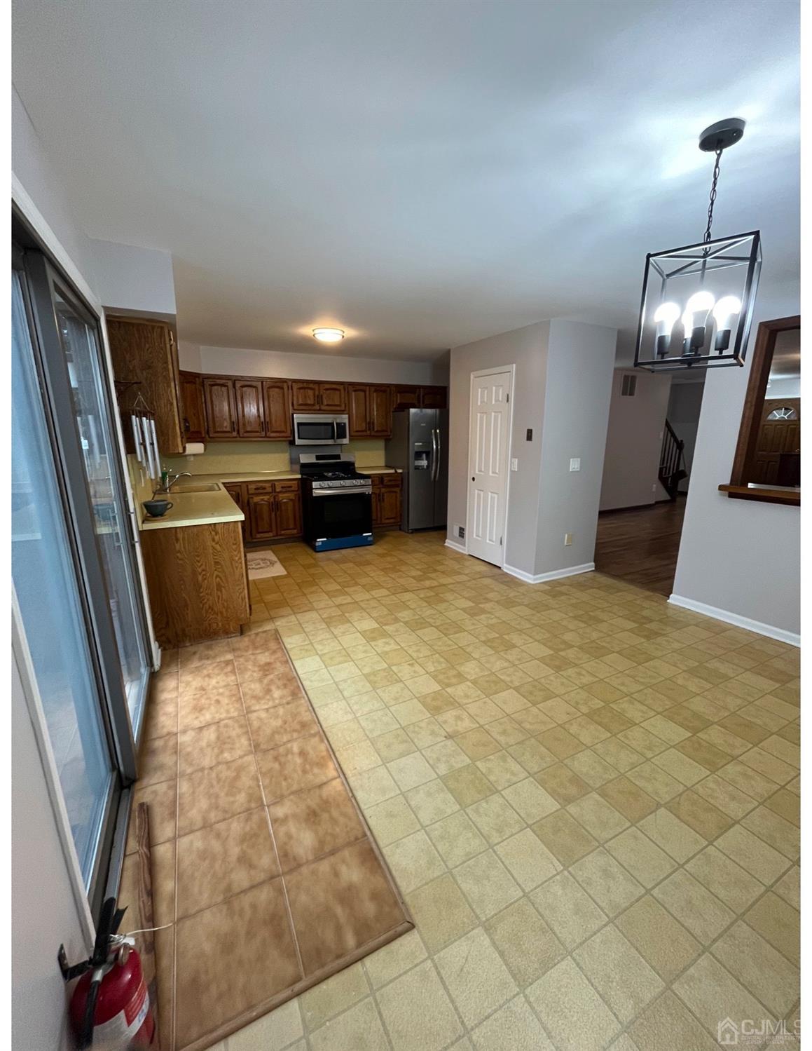 23 Pendleton Place Old Bridge, NJ 08857 - Photo 10 of 14 a living room with furniture and a chandelier