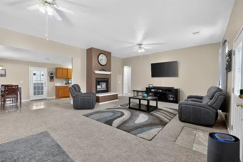 a living room with furniture a clock and a fireplace