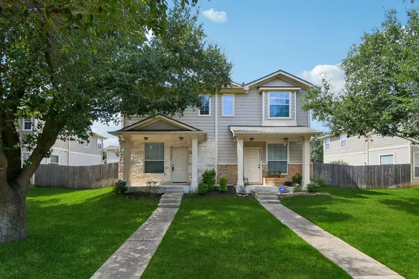 a front view of house with yard and green space