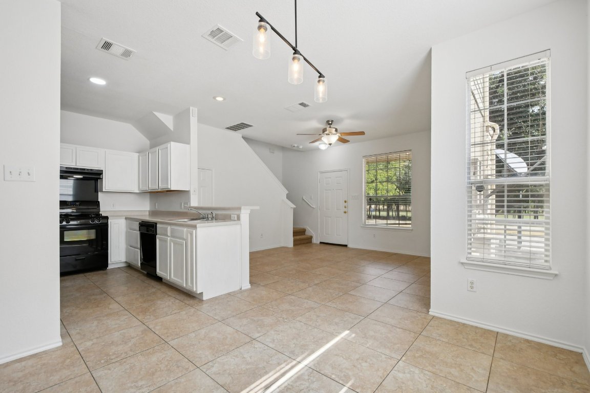 14504 Harris Ridge Boulevard, Unit A Pflugerville, TX 78660 - Photo 11 of 23 a view of a kitchen with refrigerator and microwave