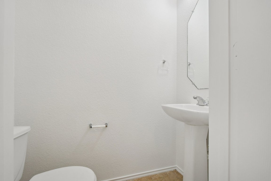 14504 Harris Ridge Boulevard, Unit A Pflugerville, TX 78660 - Photo 12 of 23 a bathroom with a sink a toilet