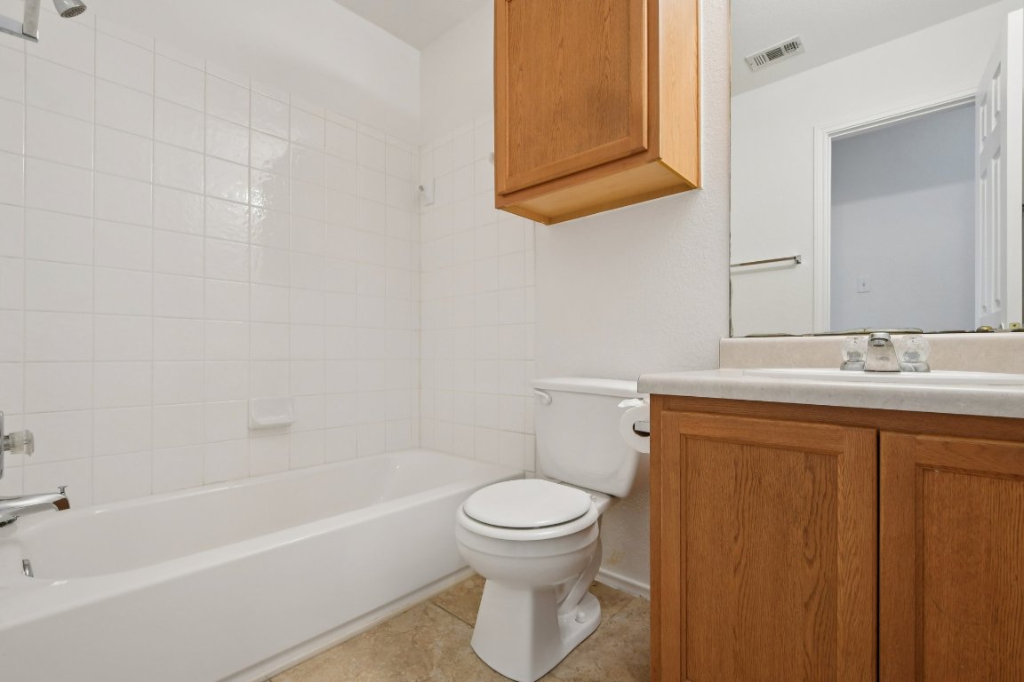 14504 Harris Ridge Boulevard, Unit A Pflugerville, TX 78660 - Photo 14 of 23 a bathroom with a sink a toilet and bathtub