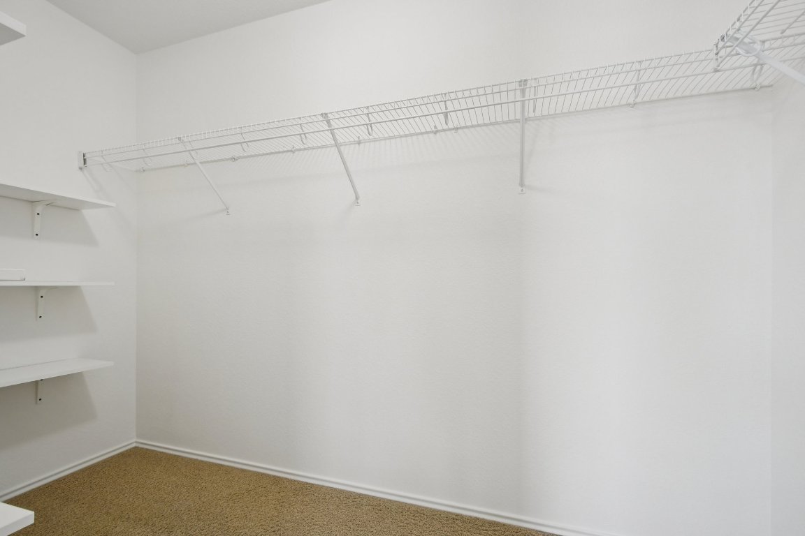 14504 Harris Ridge Boulevard, Unit A Pflugerville, TX 78660 - Photo 15 of 23 a view of a room with racks on the wall