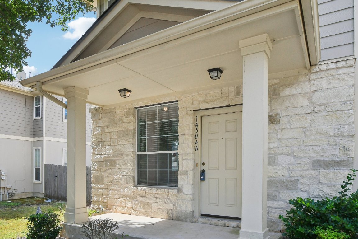 14504 Harris Ridge Boulevard, Unit A Pflugerville, TX 78660 - Photo 4 of 23 a front view of a house with a yard