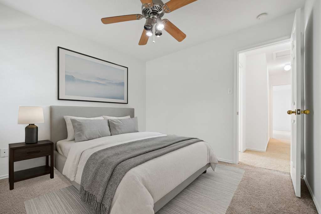 14504 Harris Ridge Boulevard, Unit A Pflugerville, TX 78660 - Photo 6 of 23 a bedroom with a bed and a chandelier