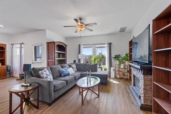 a living room with furniture a ceiling fan and a rug
