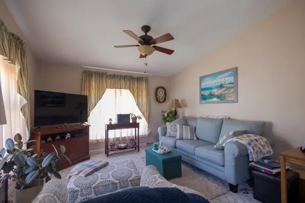 a living room with furniture fireplace and flat screen tv