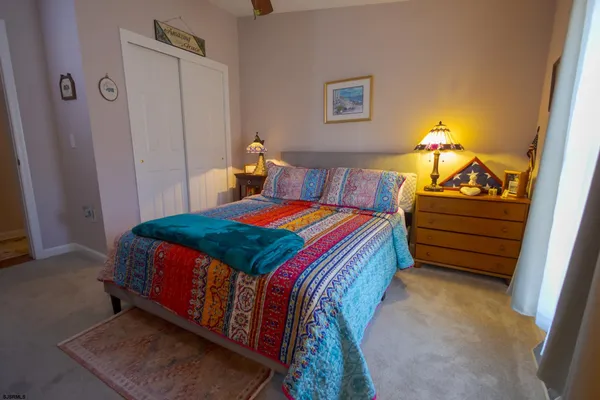 a spacious bedroom with a bed dresser and a window
