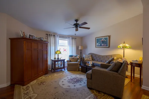 a living room with furniture and a chandelier