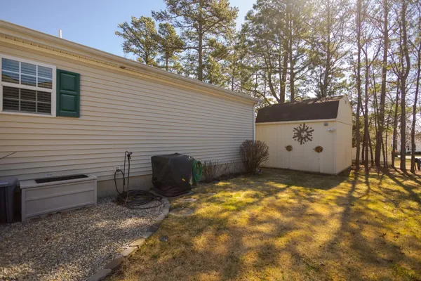 a view of a house with a yard and sitting area
