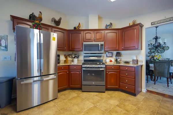 a kitchen with stainless steel appliances granite countertop a refrigerator stove and sink