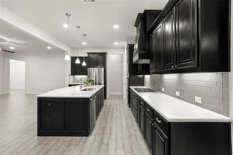 a kitchen with stainless steel appliances granite countertop counter space a sink and cabinets