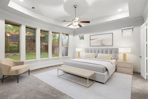 a spacious bedroom with a bed couch chandelier windows and a chandelier