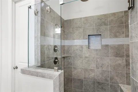 a bathroom with a granite countertop shower