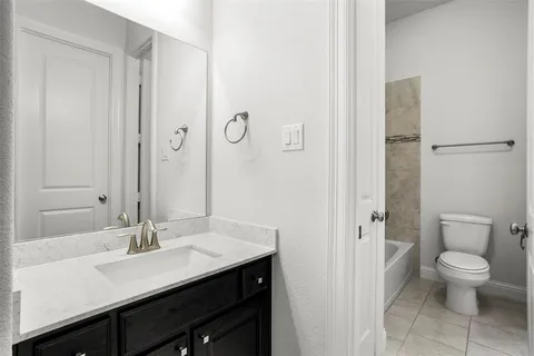 a bathroom with a granite countertop sink toilet a large mirror and shower