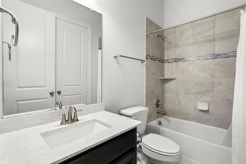 a bathroom with a sink a toilet and a bathtub