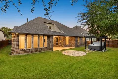 a view of a house with pool and sitting area