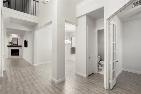 a view of a hallway with wooden floor and staircase
