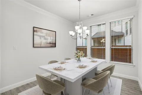 a view of a dining room with furniture wooden floor and chandelier