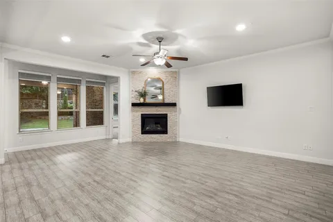 a view of an empty room with a fireplace and a window