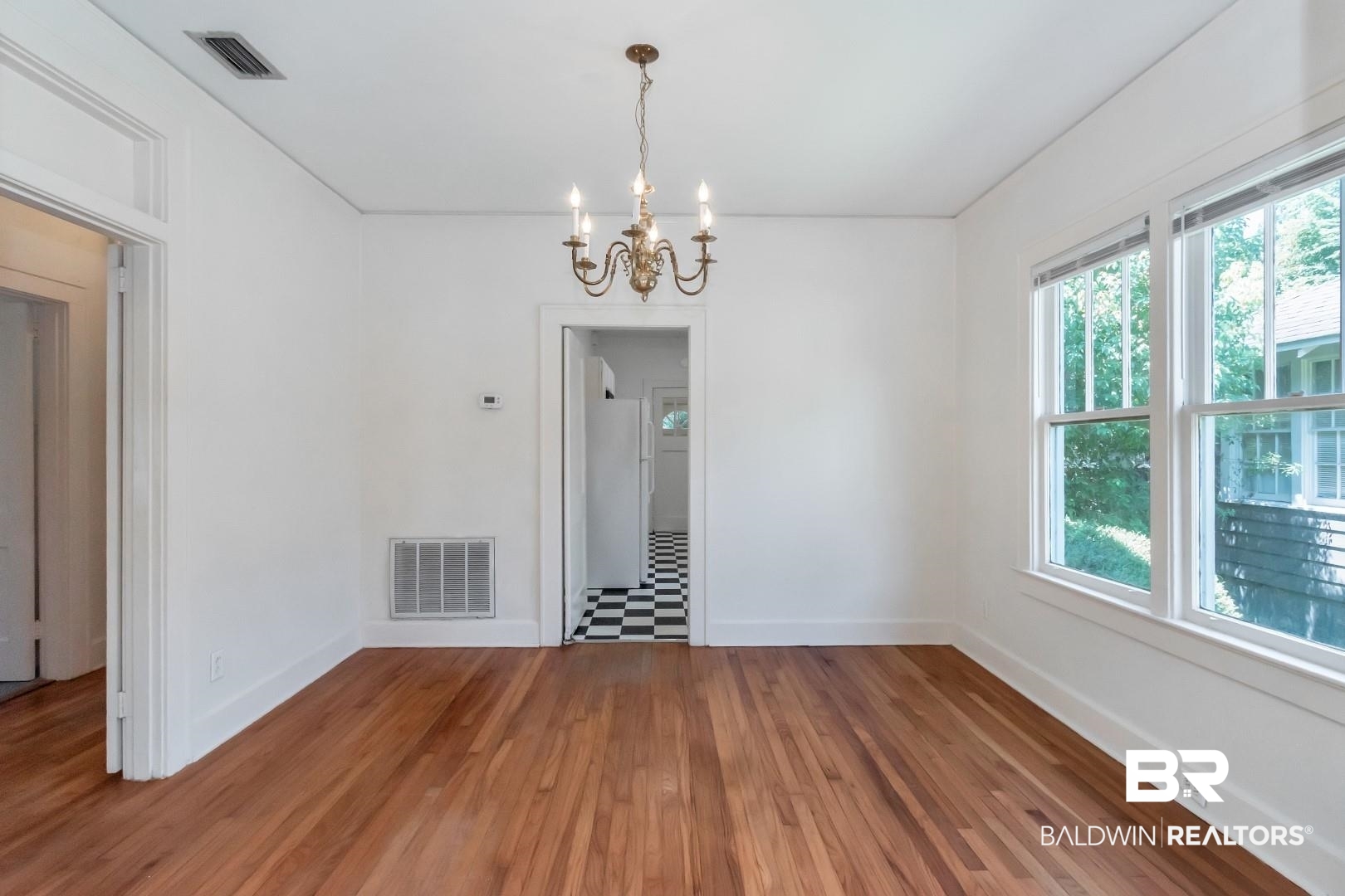 112 South Fulton Street Mobile, AL 36606 - Photo 14 of 35 Spare room with hardwood / wood-style floors and a notable chandelier