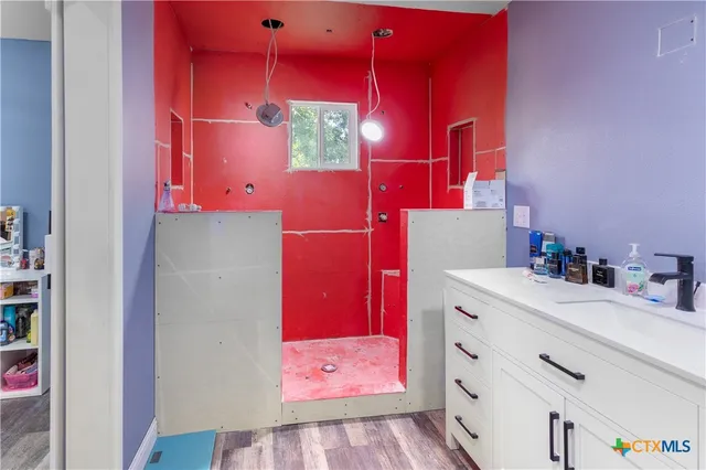 a bathroom with a sink vanity and a mirror
