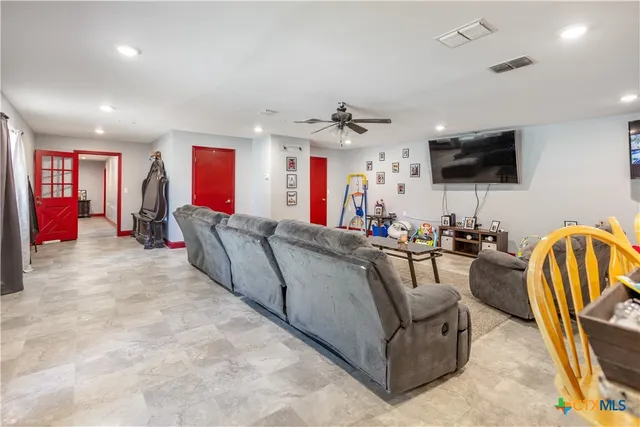 a living room with furniture and a flat screen tv