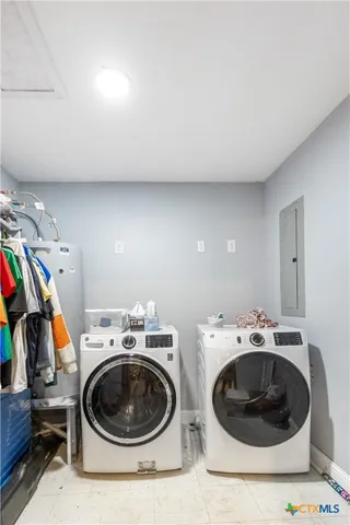 a utility room with sink washer and dryer