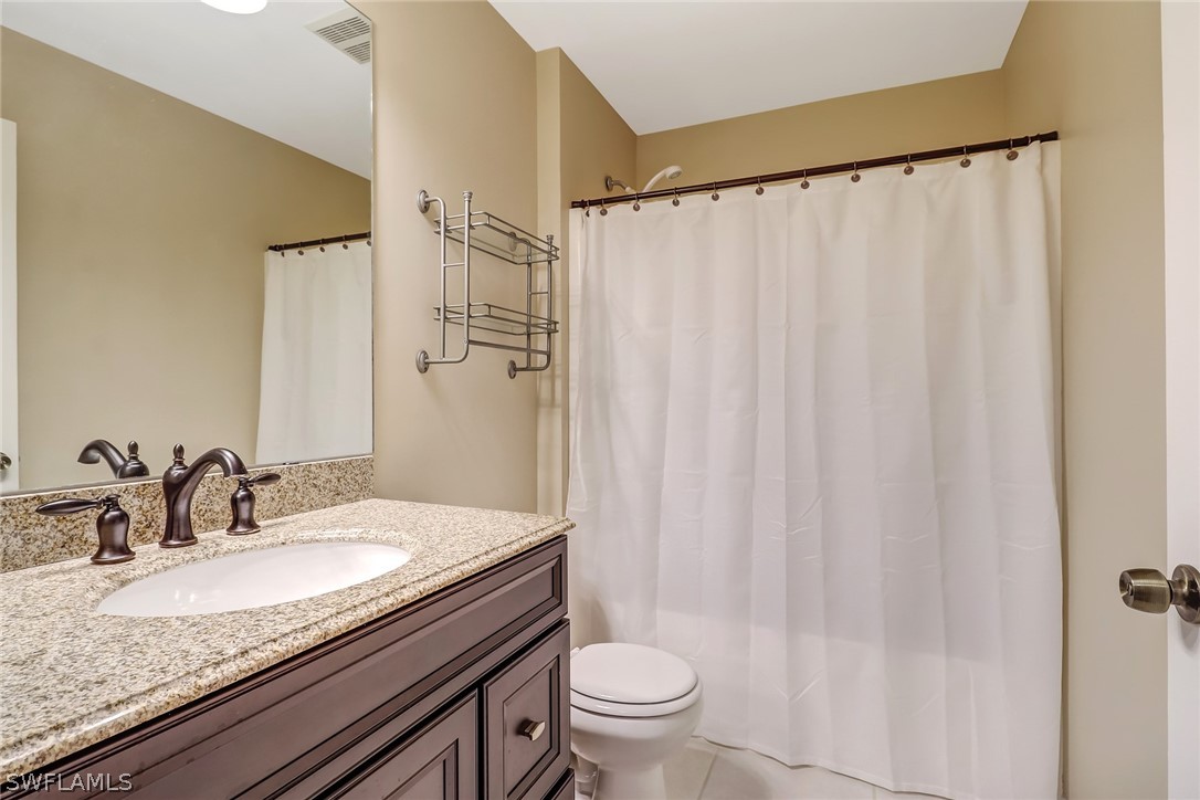 9050 Henry Road Fort Myers, FL 33967 - Photo 13 of 16 a bathroom with a granite countertop sink and a mirror