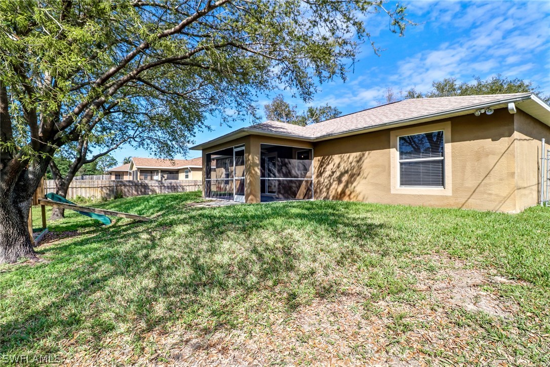 9050 Henry Road Fort Myers, FL 33967 - Photo 16 of 16 a front view of a house with garden