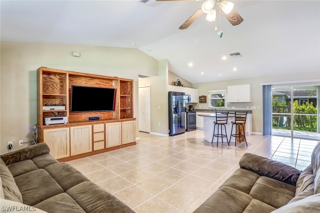 9050 Henry Road Fort Myers, FL 33967 - Photo 3 of 16 a living room with furniture and a flat screen tv
