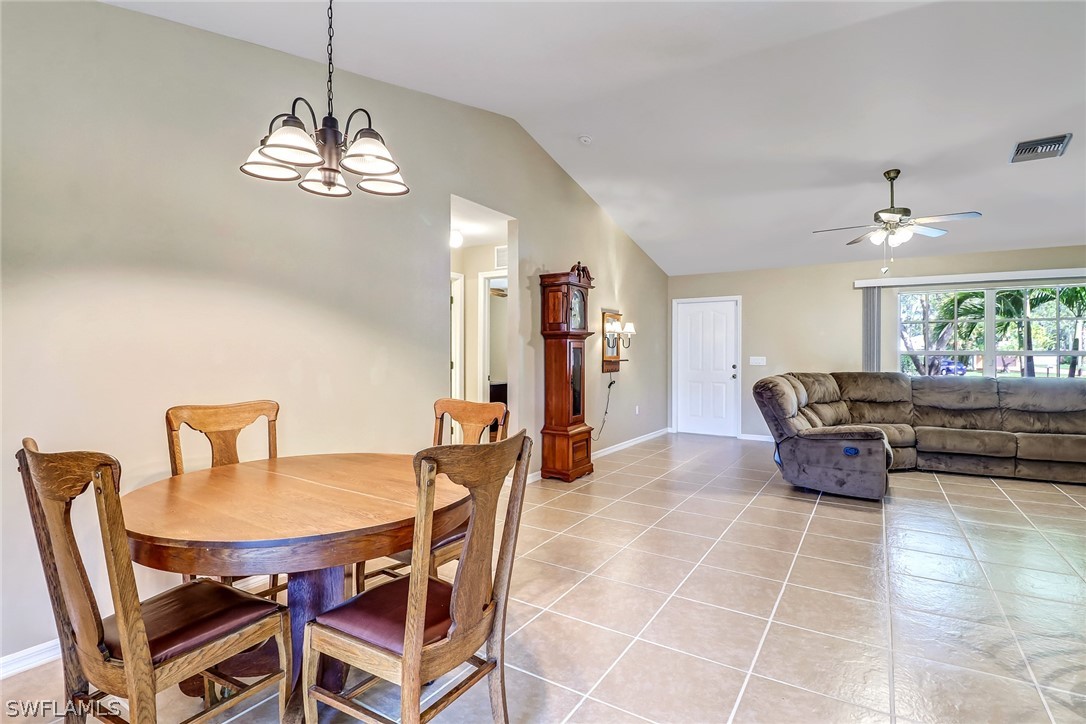 9050 Henry Road Fort Myers, FL 33967 - Photo 5 of 16 a dining room with furniture a chandelier and a rug