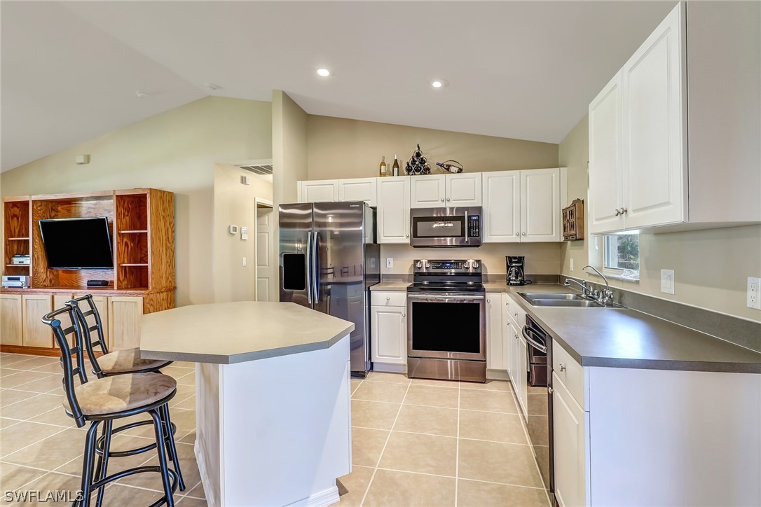 9050 Henry Road Fort Myers, FL 33967 - Photo 6 of 16 a kitchen with stainless steel appliances granite countertop a sink stove and refrigerator